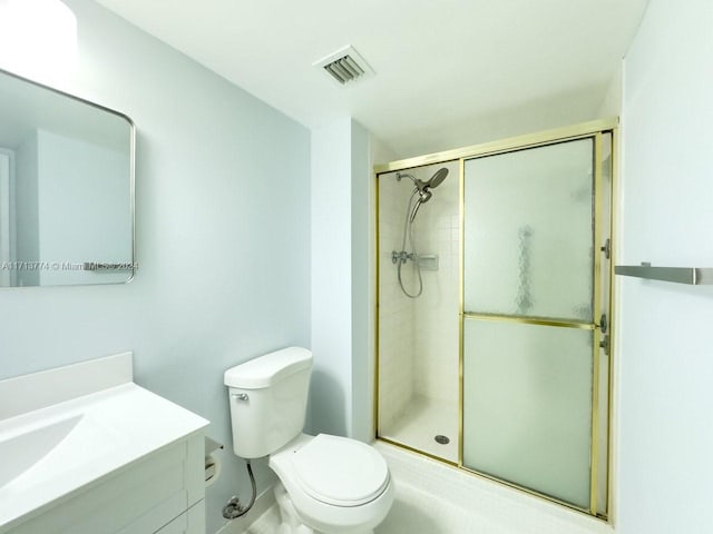 bathroom with walk in shower, vanity, and toilet