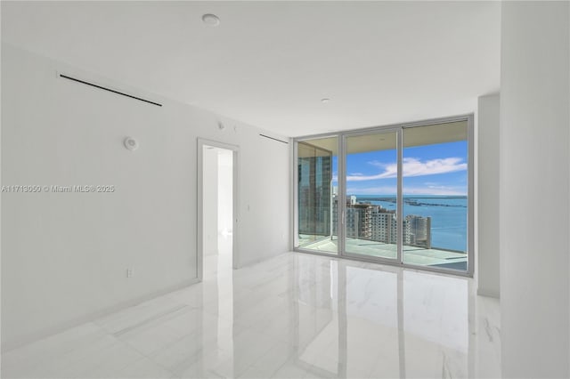 empty room with floor to ceiling windows and a water view