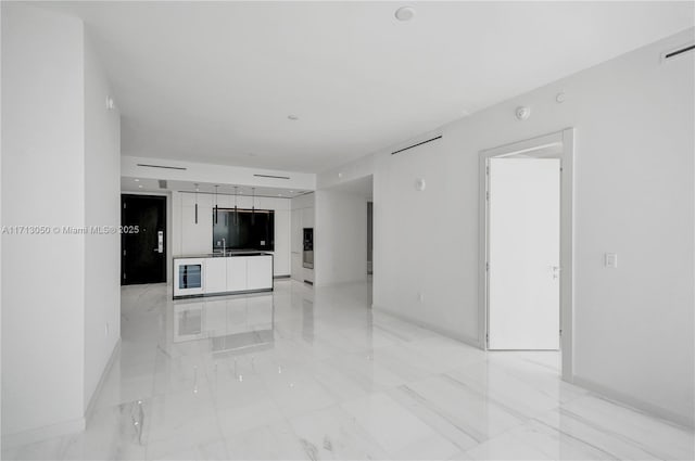 unfurnished living room featuring sink