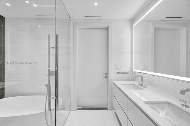 bathroom featuring vanity and shower with separate bathtub