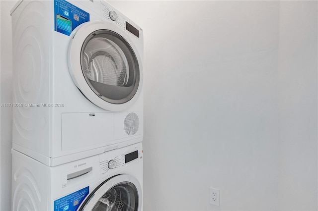 laundry area with stacked washer and clothes dryer