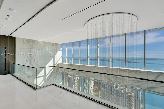 hallway featuring a water view and a view of the beach