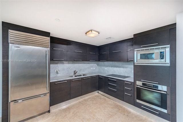 kitchen with sink, stainless steel appliances, and tasteful backsplash