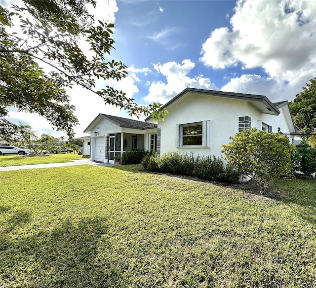 view of front of home featuring a garage and a front lawn