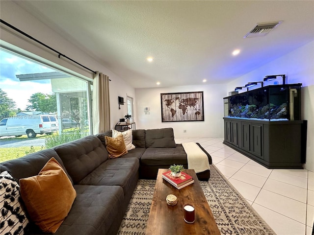 living room featuring light tile patterned floors and a textured ceiling