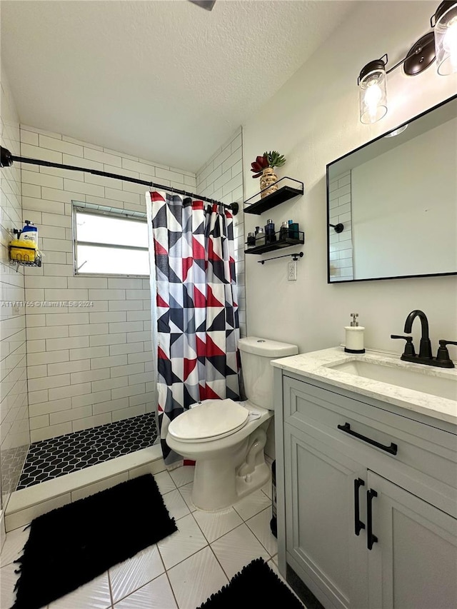 bathroom featuring vanity, tile patterned flooring, toilet, a textured ceiling, and curtained shower