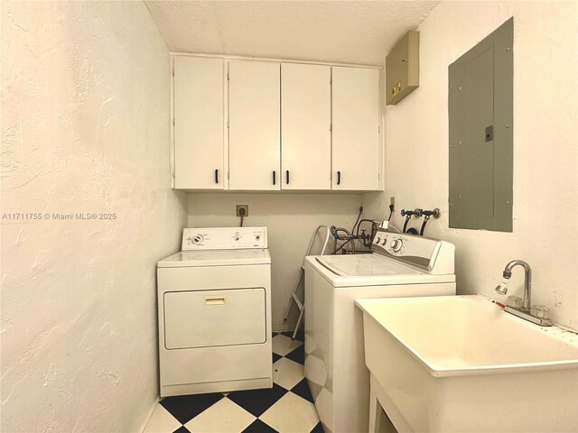 clothes washing area with sink, cabinets, independent washer and dryer, electric panel, and a textured ceiling