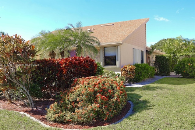 view of property exterior with a lawn