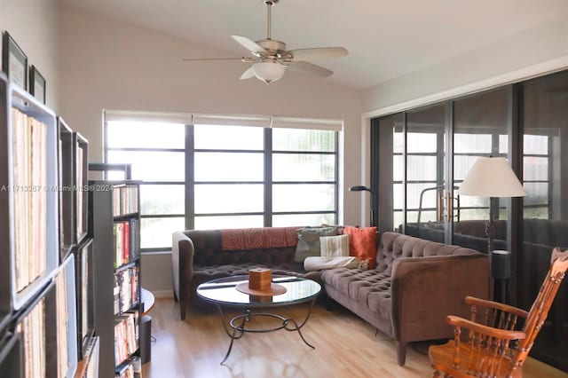 living room featuring ceiling fan, wood-type flooring, and lofted ceiling