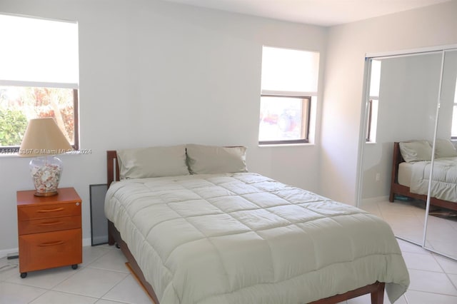 bedroom with a closet and light tile patterned flooring