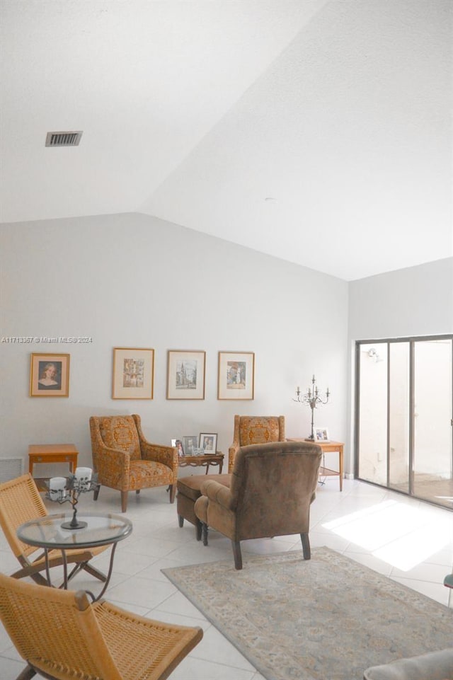 tiled living room featuring lofted ceiling