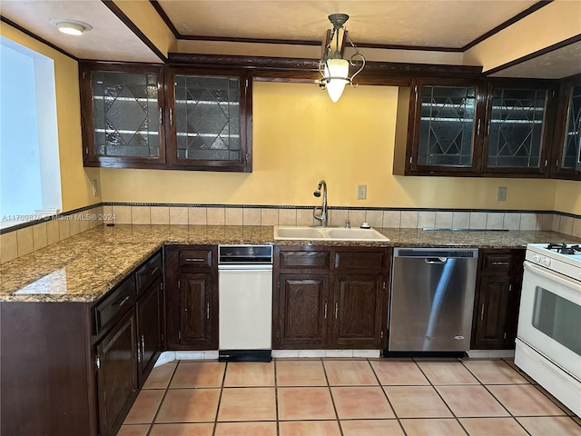 kitchen featuring dishwasher, sink, pendant lighting, light tile patterned floors, and white stove