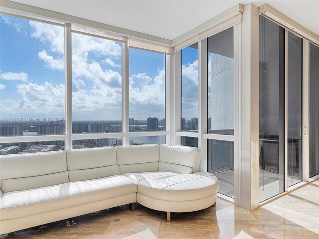 sunroom / solarium featuring plenty of natural light and a water view