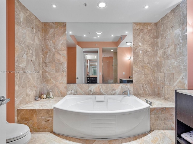 bathroom featuring a washtub, toilet, and tile walls