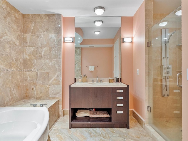 bathroom with vanity and separate shower and tub