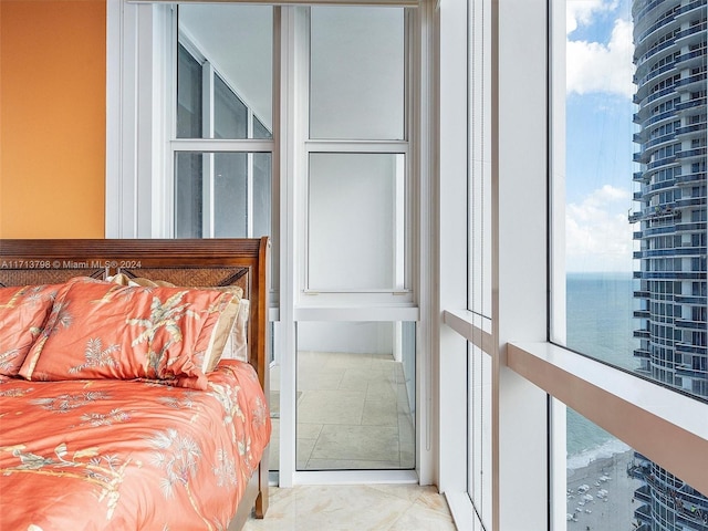 bedroom featuring multiple windows and a water view