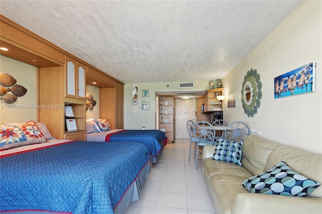 tiled bedroom featuring a textured ceiling