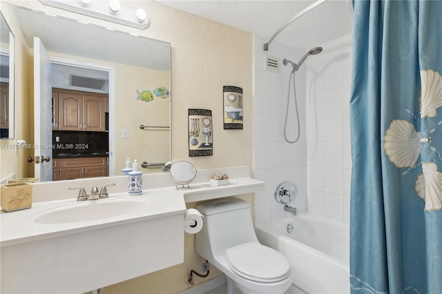 full bathroom with backsplash, sink, shower / bath combo, and toilet