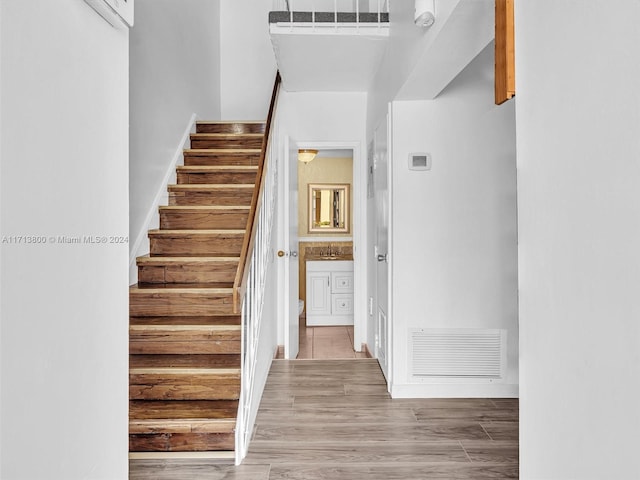 stairs featuring wood-type flooring