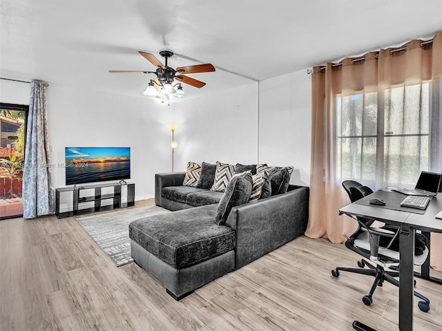 living room featuring hardwood / wood-style floors and ceiling fan