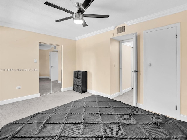 unfurnished bedroom featuring ceiling fan, a closet, carpet floors, and ornamental molding