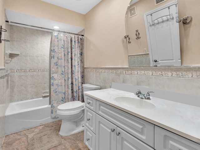 full bathroom featuring shower / bathtub combination with curtain, vanity, tile walls, and toilet