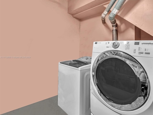 laundry area featuring washing machine and clothes dryer