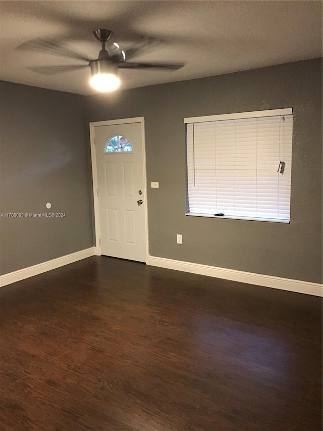 foyer entrance featuring a textured ceiling, dark hardwood / wood-style floors, and ceiling fan