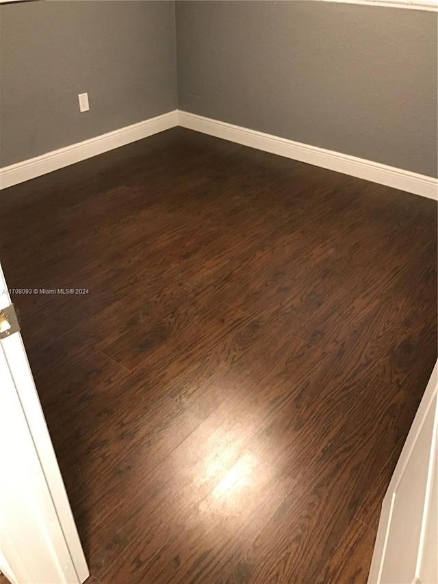 empty room with dark wood-type flooring