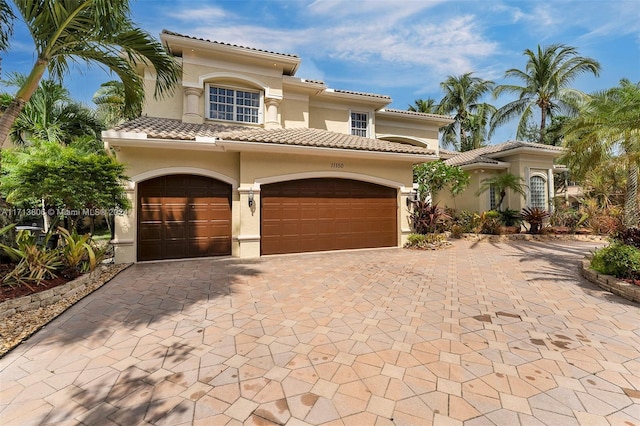 mediterranean / spanish house featuring a garage