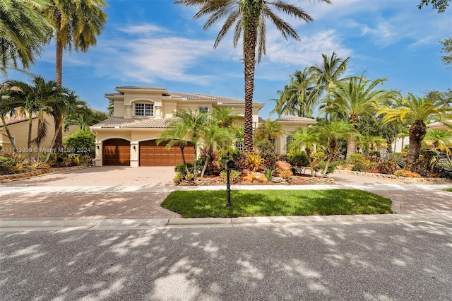 mediterranean / spanish-style house with a garage