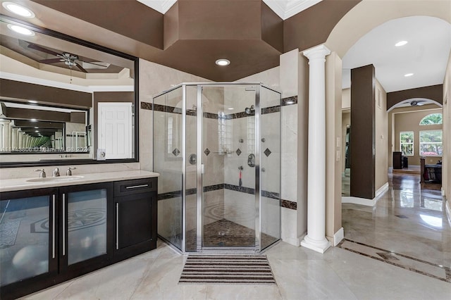 bathroom featuring vanity, ceiling fan, a shower with shower door, and ornate columns