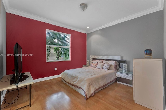 bedroom featuring crown molding and light hardwood / wood-style flooring