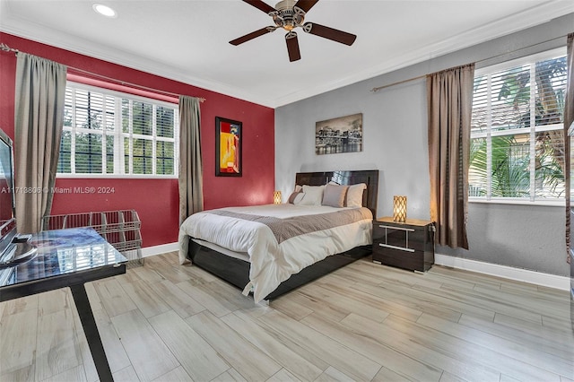 bedroom featuring multiple windows, ceiling fan, ornamental molding, and light wood-type flooring