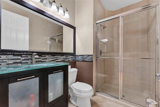 bathroom featuring decorative backsplash, tile patterned floors, walk in shower, vanity, and toilet