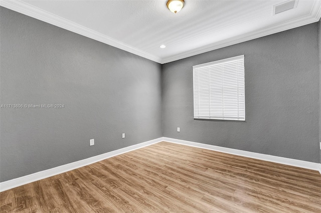 unfurnished room with crown molding and hardwood / wood-style floors