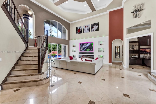 living room with crown molding, a high ceiling, and coffered ceiling