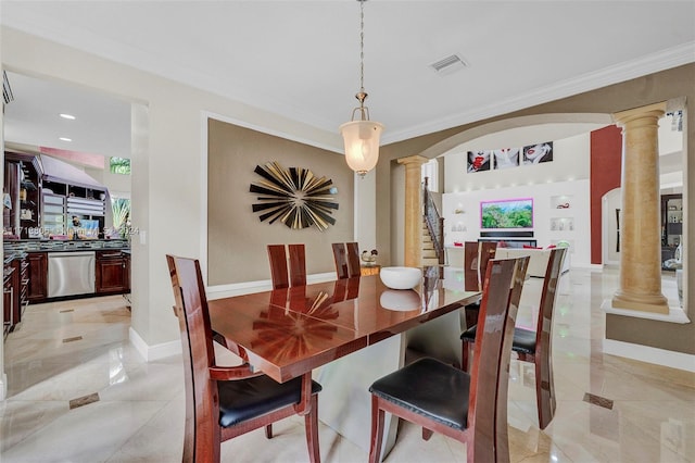 dining room featuring decorative columns and ornamental molding