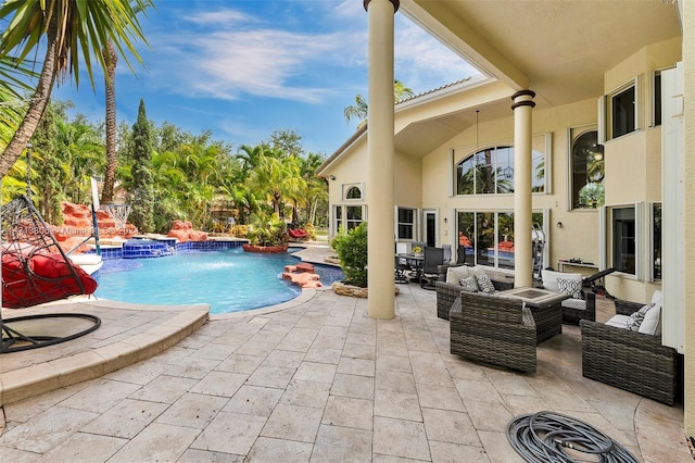 view of swimming pool featuring pool water feature, an outdoor hangout area, a jacuzzi, and a patio