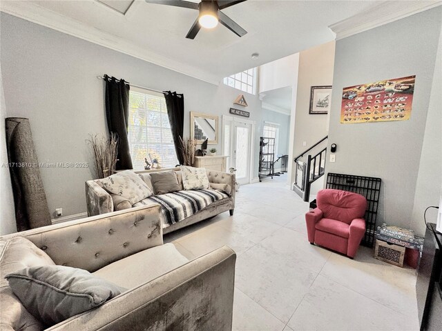 living room featuring ceiling fan, crown molding, and light tile patterned floors