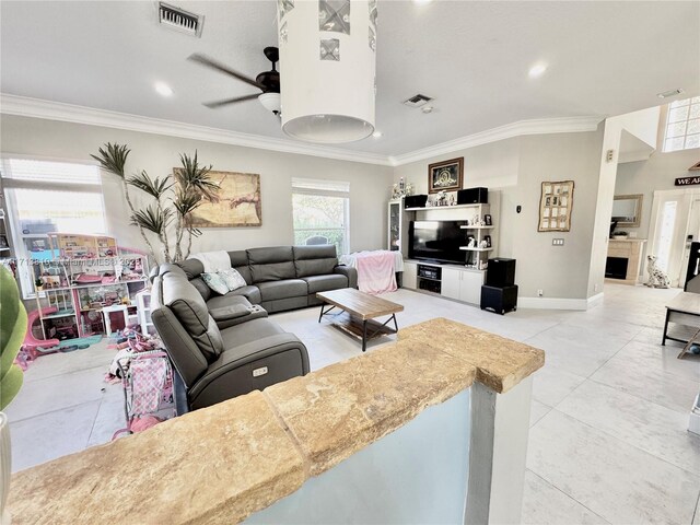 kitchen featuring electric range, a breakfast bar area, ornamental molding, sink, and decorative light fixtures