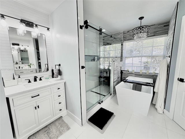 bathroom featuring an inviting chandelier, tile patterned floors, independent shower and bath, and vanity