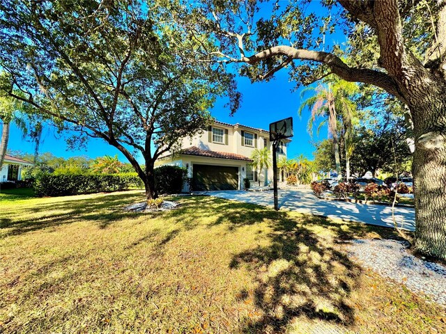 view of front facade with a front yard and a garage