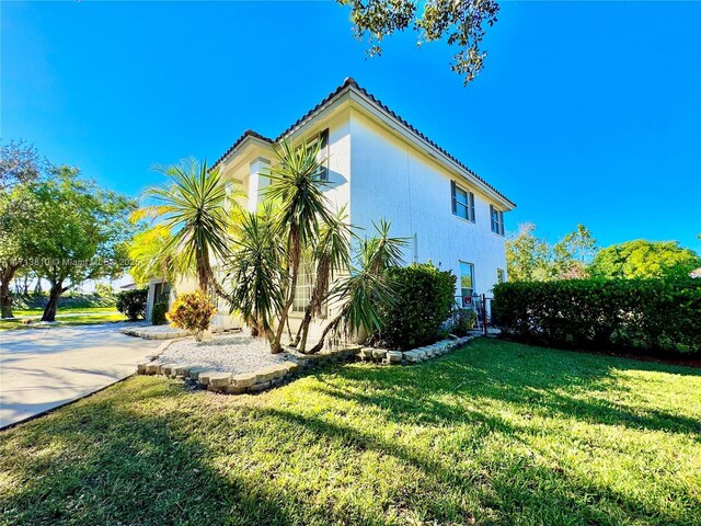 view of side of property with a lawn