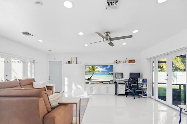 living room featuring ceiling fan and french doors