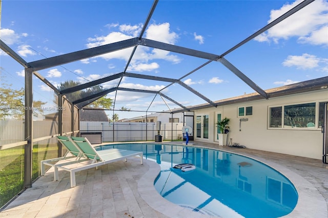 view of swimming pool featuring glass enclosure and a patio area