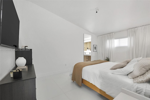 bedroom featuring tile patterned flooring and vaulted ceiling