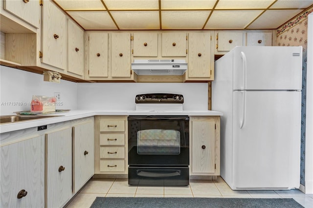 kitchen featuring white refrigerator, black electric range oven, and light tile patterned floors