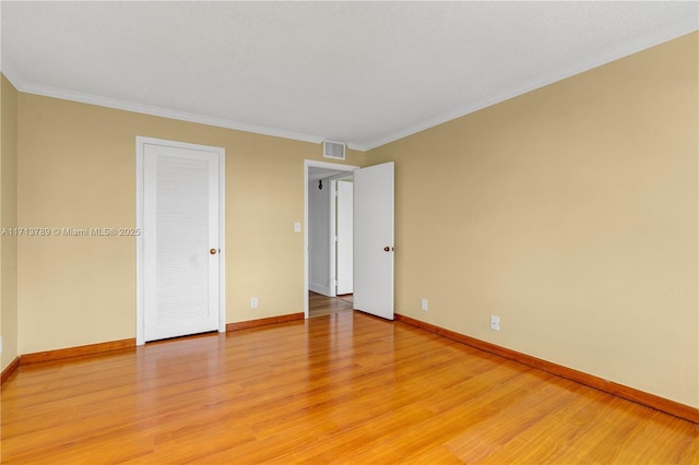 spare room with light hardwood / wood-style floors and ornamental molding