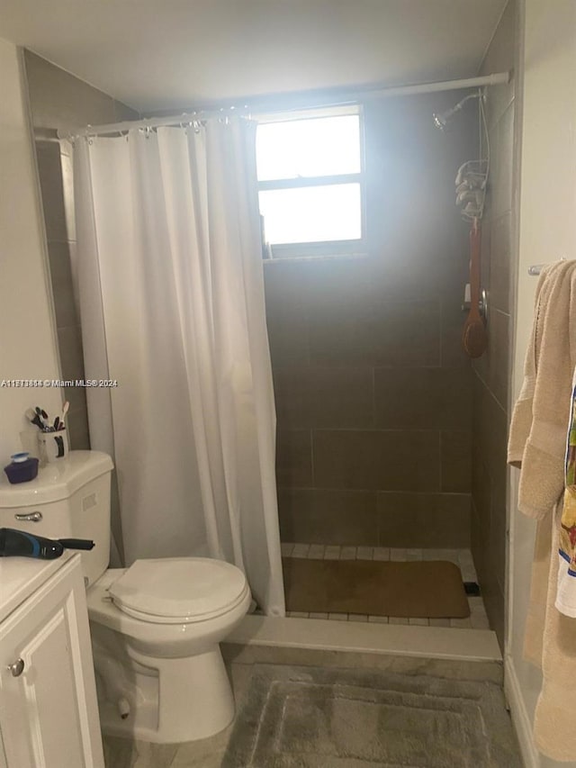 bathroom with vanity, toilet, and walk in shower